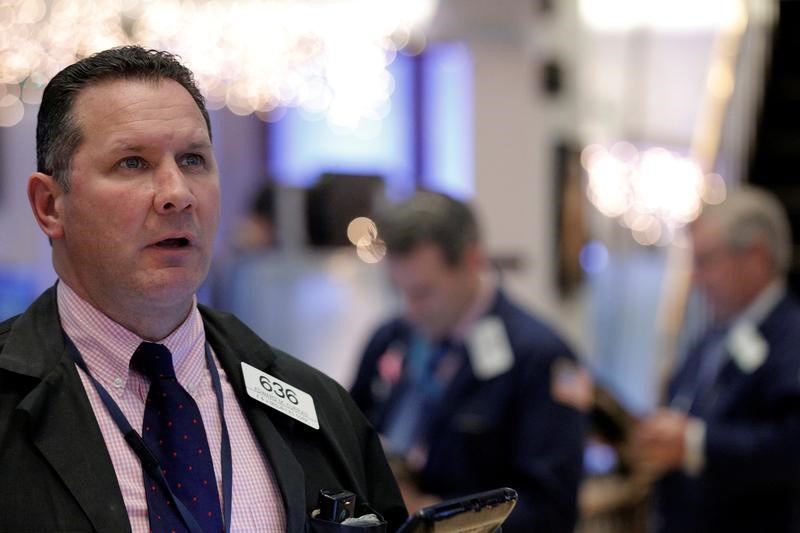Asian stocks mostly higher on record Dow, telecom news
