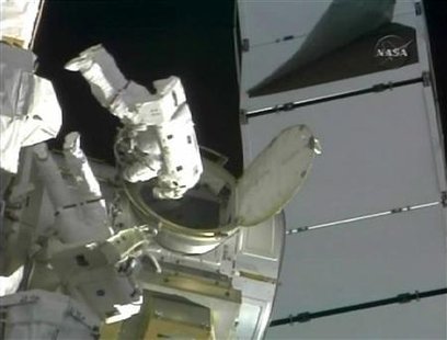 Space Shuttle Discovery astronauts Danny Olivas and Nicole Stott exit the International Space Station's Qwest airlock at the beginning of their spacewalk in this image from NASA TV September 1, 2009. REUTERS/NASA TV
Space Shuttle Discovery astronauts Danny Olivas and Nicole Stott exit the International Space Station's Qwest airlock at the beginning of their spacewalk in this image from NASA TV September 1, 2009. REUTERS/NASA TV
