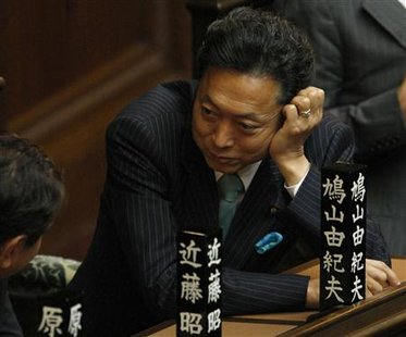 




Japan's new Prime Minister Yukio Hatoyama talks with his Democratic Party's lawmaker before a lower house plenary session at Parliament in Tokyo September 18, 2009. REUTERS/Toru Hanai

