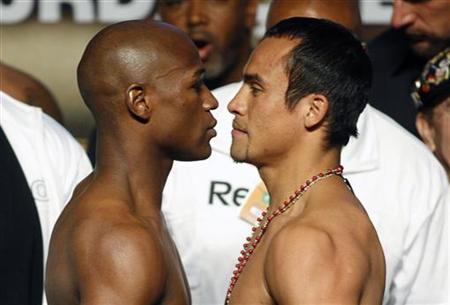 




Boxers Floyd Mayweather Jr. (L) of the U.S. and Juan Manuel Marquez of Mexico face off following an official weigh-in at the MGM Grand Garden Arena in Las Vegas, Nevada September 18, 2009. REUTERS/Steve Marcus


