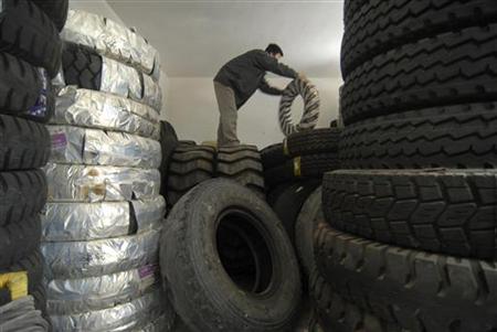 An employee moves tyres at a tyre shop in Baokang, Hubei province, September 12, 2009. REUTERS/Stringer
An employee moves tyres at a tyre shop in Baokang, Hubei province, September 12, 2009. REUTERS/Stringer