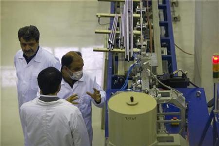 




A technician explains the workings of a machine to a government visitor during the inauguration of the Fuel Manufacturing plant at the Isfahan Uranium Conversion Facility 440 kilometres (274 miles) south of Tehran April 9, 2009. REUTERS/Caren Firouz

