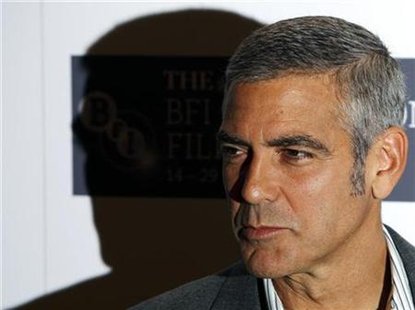




U.S. actor George Clooney poses for photographers as arrives to speak about his new film "Fantastic Mr. Fox" in London, October 14, 2009. REUTERS/Luke MacGregor

