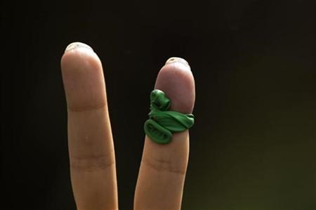 




A supporter of defeated presidential candidate and opposition leader Mirhossein Mousavi shows a victory sign with a piece of balloon in the signature colour of his campaign tied on a finger during a rally marking Qods (Jerusalem) Day in Tehran in this September 18, 2009 file photo. REUTERS/Caren Firouz

