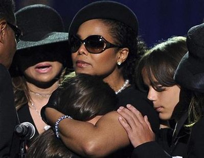 
Michael Jackson's son, Prince Michael Jackson I (R), leans on the shoulder of his aunt Janet Jackson, as she comforts Paris Jackson, Michael Jackson's daughter, at a memorial service for Michael Jackson in Los Angeles, July 7, 2009. REUTERS/Gabriel Bouys/Pool
