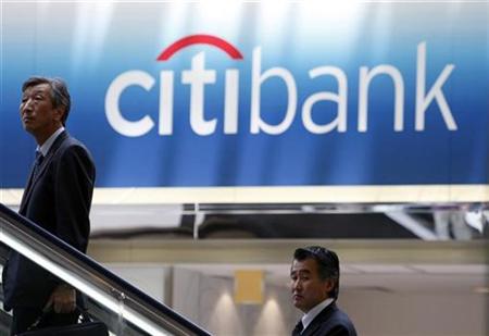 
Men travel on an escalator near a Citibank signboard in Tokyo in this June 26, 2009 file photo. REUTERS/Kim Kyung-Hoon
