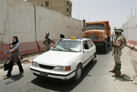 




Iraqi soldiers stand guard at a checkpoint in Baghdad's Saidiya district July 8, 2009. REUTERS/Saad Shalash

