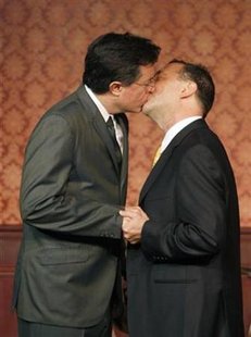 
Stephen Colbert (L) kisses Dave Razowsky as they perform in a skit as part of the 50th anniversary of improv theater, The Second City, in Chicago December 12, 2009. REUTERS/Frank Polich
