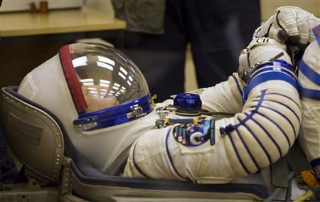 Japan Aerospace Exploration Agency astronaut Soichi Noguchi waits while ground personnel check his space suit at the Baikonur cosmodrome December 20, 2009. REUTERS/Shamil Zhumatov
Japan Aerospace Exploration Agency astronaut Soichi Noguchi waits while ground personnel check his space suit at the Baikonur cosmodrome December 20, 2009. REUTERS/Shamil Zhumatov