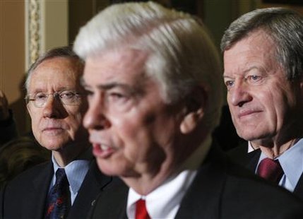 
U.S. Senate Majority Leader Harry Reid (D-NV) (L) and Senator Max Baucus (D-MT) (R) listen to Senator Christopher Dodd (D-CT) after the U.S. Senate approved President Barack Obama's healthcare overhaul on Capitol Hill in Washington December 24, 2009. REUTERS/Jim Young
