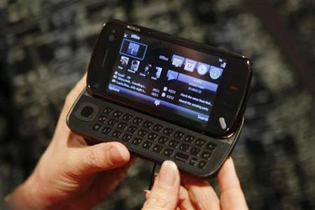 
A model holds a new 'Nokia N97' phone during the 'Nokia World 08' congress in Barcelona in this December 2, 2008 file photo. REUTERS/Albert Gea
