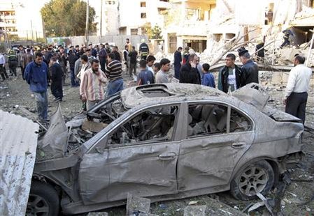 
Residents gather at the site of a bomb attack in central Baghdad January 25, 2010. At least 36 people were killed on Monday in a series of car bombs detonated at three well-known hotels in downtown Baghdad, police said. REUTERS/Mohammed Ameen
