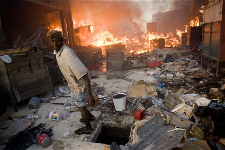 A man stands as fire engulf stores in downtown Port-au-Prince January 29, 2010. Aid groups and troops from around the world have struggled to distribute food, water and medical care to an estimated 3 million Haitians injured or left homeless in the 7.0-magnitude earthquake that wrecked much of Haiti's capital on January 12, killing as many as 200,000 people. REUTERS/Marco Dormino/UN/MINUSTAH/Handout
A man stands as fire engulf stores in downtown Port-au-Prince January 29, 2010. Aid groups and troops from around the world have struggled to distribute food, water and medical care to an estimated 3 million Haitians injured or left homeless in the 7.0-magnitude earthquake that wrecked much of Haiti's capital on January 12, killing as many as 200,000 people. REUTERS/Marco Dormino/UN/MINUSTAH/Handout