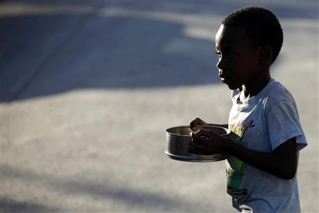 A boy walks past after receiving food from a Haitian foundation in downtown Port-au-Prince January 29, 2010. REUTERS/Jorge Silva
A boy walks past after receiving food from a Haitian foundation in downtown Port-au-Prince January 29, 2010. REUTERS/Jorge Silva