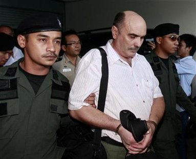 Police escort crew member Vitaliy Shunkov of Kazakhstan at The Criminal Court in Bangkok December 14, 2009. REUTERS/Chaiwat Subprasom
Police escort crew member Vitaliy Shunkov of Kazakhstan at The Criminal Court in Bangkok December 14, 2009. REUTERS/Chaiwat Subprasom