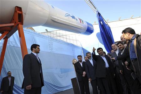 
Iranian President Mahmoud Ahmadinejad (5th L) looks at the domestically produced Simorq rocket to carry satellites into space during a ceremony in Tehran February 3, 2010. REUTERS/Ebrahim Noroozi/IIPA.ir
