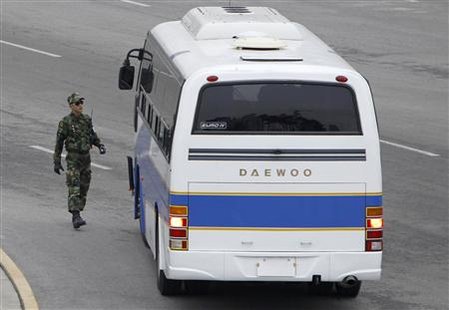 
A border security soldier of South Korea checks a bus carrying a South Korean delegation at the CIQ (customs, immigration and quarantine) office, just south of the demilitarized zone separating the two Koreas, in Paju, north of Seoul February 8, 2010. REUTERS/Lee Jae-Won
