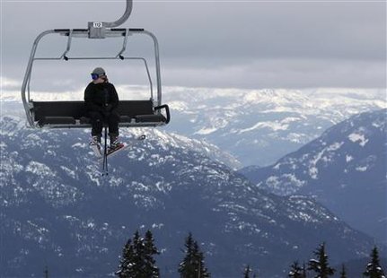 
A skier sits on a chairlift over the downhill course of the Vancouver 2010 Winter Olympics in Whistler, British Columbia, February 7, 2010. REUTERS/Wolfgang Rattay
