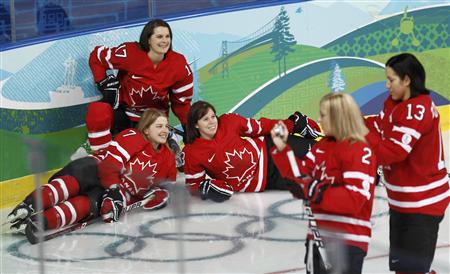 
Members of the Canadian women's ice hockey team (L-R) Cherie Piper, Jennifer Botterill and Carla MacLeod pose for pictures during practice in preparation for Vancouver 2010 Winter Olympics games in Vancouver, British Columbia February 9, 2010. REUTERS/Shaun Best
