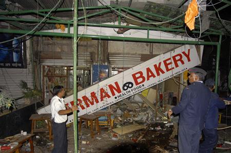 
Firefighters examine the site of a bomb blast at the German Bakery restaurant in Pune February 13, 2010. REUTERS/Stringer
