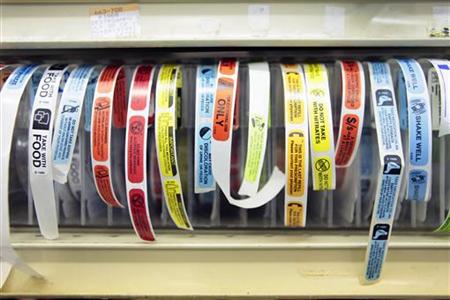
Stickers to be placed on prescription medication bottles sit in a shelf at a pharmacy in New York December 23, 2009. REUTERS/Lucas Jackson
