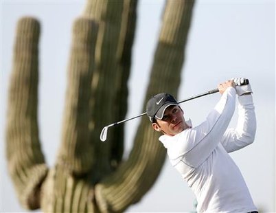 
Paul Casey of England watches his tee shot on the fourth hole during the quarterfinal round of the WGC-Accenture Match Play Championship golf tournament in Marana, Arizona February 20, 2010. REUTERS/Matt Sullivan
