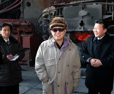 
North Korea's leader Kim Jong-il (C) poses as he visits the Hwanghae Iron and Steel Complex in Songnim in north Hwanghae province, south of Pyongyang in this picture released by the North's KCNA news agency on February 21, 2010. REUTERS/KCNA
