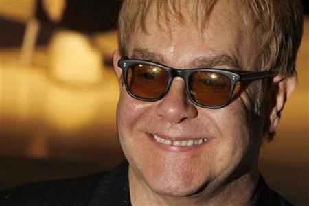 Singer songwriter Elton John poses for photographers as he opens charity store 'Out the Closet' in Covent Garden in London, December 11, 2009. REUTERS/Luke MacGregor
Singer songwriter Elton John poses for photographers as he opens charity store 'Out the Closet' in Covent Garden in London, December 11, 2009. REUTERS/Luke MacGregor