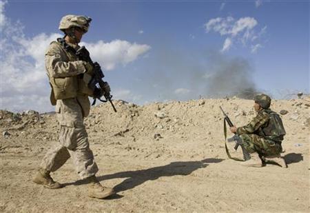 
A U.S. Marine patrols next to a soldier of the Afghan National Army (ANA) in the town of Now Zad in Helmand province, southern Afghanistan, March 7, 2010. REUTERS/Shamil Zhumatov
