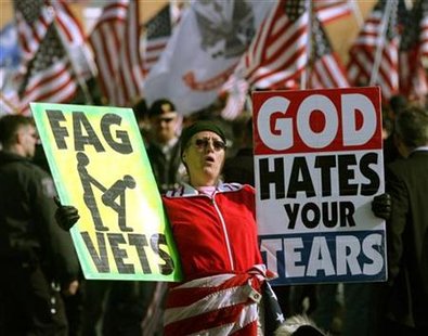 
A member of a religious extremist group from Kansas pickets outside the funeral of an Army National Guard soldier who died last Wednesday from injuries he suffered in Iraq in Flushing, Michigan March 11, 2006 file photo. REUTERS/Rebecca Cook
