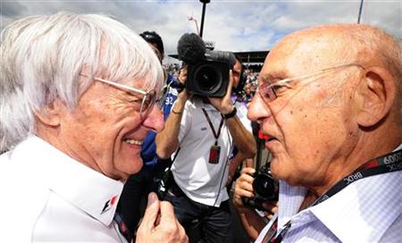 
Formula One commercial supremo Bernie Ecclestone (L) talks to former racing driver Stirling Moss on the grid before the British F1 Grand Prix at Silverstone, central England, June 21, 2009 file photo. REUTERS/Nigel Roddis
