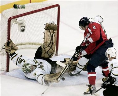 
Dallas Stars goalie Marty Turco makes a sprawling save on a shot by Alex Ovechkin (8) of the Washington Capitals as Stars' Stephane Robidas (3) moves in during the first period of their NHL hockey game in Washington March 8, 2010. REUTERS/Joe Giza
