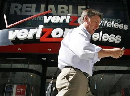 




A man looks at his phone as he walks past a Verizon wireless store in New York, July 30, 2009. REUTERS/Brendan McDermid

