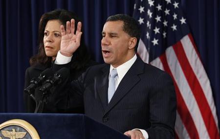 
New York Gov. David Paterson, with his wife Michelle Paige-Patterson standing by him, announces he will withdraw from the state governor's race at his office in New York, February 26, 2010. REUTERS/Jessica Rinaldi
