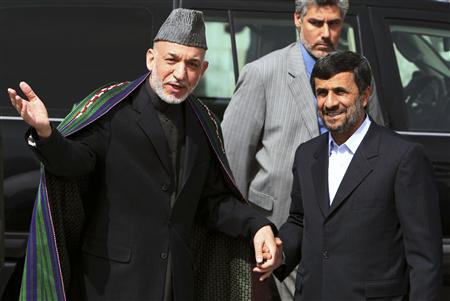 
Afghan President Hamid Karzai (L) welcomes his Iranian counterpart Mahmoud Ahmadinejad upon his arrival in Kabul March 10, 2010. REUTERS/Sorkhabi/Pool
