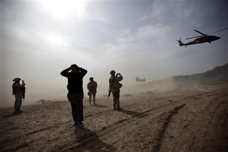 
Two helicopters escorting U.S. Secretary of Defense Robert Gates take off after a visit to Camp Black Horse where the Afghan National Army (ANA) receive training in Kabul March 10, 2010. REUTERS/Ahmad Masood

