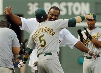 
Former Boston Red Sox left fielder and Hall of Famer Jim Rice (rear) gets a hug from Oakland Athletics first baseman Nomar Garciaparra as Rice walks onto the field for ceremonies to retire his number 14 at Fenway Park in Boston, Massachusetts July 28, 2009 file photo. REUTERS/Brian Snyder
