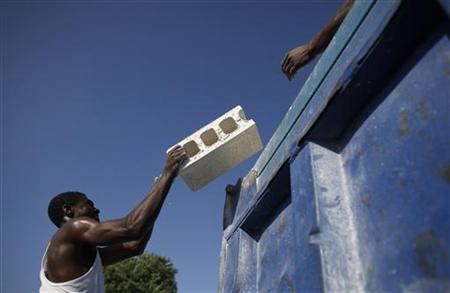 
Haitians load up blocks to be used for construction to a truck in Port-au-Prince February 3, 2010. REUTERS/Eliana Aponte
