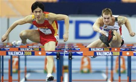 
China's Liu Xiang (L) and Germany's Thomas Blaschek compete in the men's 60 metres hurdles final at the 12th IAAF World Indoor Athletics Championship in Valencia March 8, 2008 file photo. Reuters/Heino Kalis
