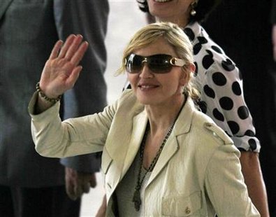 
U.S. singer Madonna waves to fans as she arrives at Bandeirantes Palace to meet Sao Paulo's governor Jose Serra in this February 10, 2010 file photo. REUTERS/Paulo Whitaker
