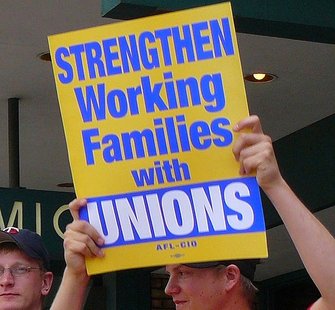 A worker holds a union sign.
