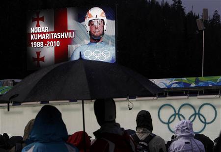 
People observe a moment of silence for Georgian luger Nodar Kumaritashvili, who crashed and died, before the first run of the men's singles luge event at the Vancouver 2010 Winter Olympics in Whistler, British Columbia February 13, 2010. REUTERS/Jim Young

