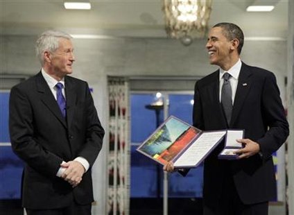 
President and Nobel Peace Prize laureate Barack Obama laughs after receiving his medal and diploma from Nobel committee chairman Thorbjorn Jagland at the Nobel Peace Prize ceremony at City Hall in Oslo in this December 10, 2009 file photo. REUTERS/John McConnico/Pool
