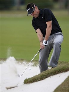 
Robert Allenby of Australia hits out of a fairway bunker on the 17th hole during first round play of the WGC-CA Championship at TPC Blue Monster at Doral in Miami, Florida March 11, 2010. REUTERS/Hans Deryk

