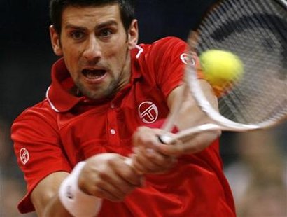 
Serbia's Novak Djokovic hits a return to John Isner of the U.S. during their Davis Cup World Group, 1st round tennis match in Belgrade in this March 7, 2010 file photo. REUTERS/Ivan Milutinovic
