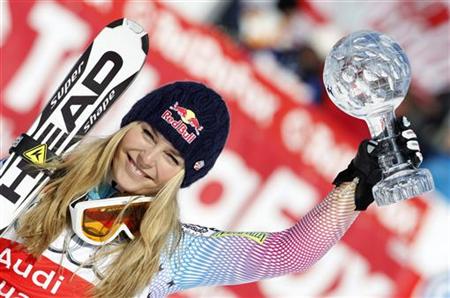 
Lindsey Vonn of the U.S. holds up the trophy after winning the women's Alpine Skiing World Cup Downhill in Garmisch-Partenkirchen March 10, 2010. REUTERS/Michaela Rehle
