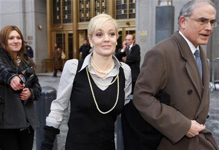 
Danielle Chiesi (C), indicted on fraud charges in a sprawling insider trading probe involving Galleon hedge fund founder Raj Rajaratnam, departs from federal court with attorney Alan Kaufman in New York, February 17, 2010. REUTERS/Chip East
