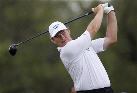 
Ernie Els of South Africa hits his tee shot in the rain on the fifth hole during second round play of the WGC-CA Championship at TPC Blue Monster at Doral in Miami, Florida March 12, 2010. REUTERS/Hans Deryk
