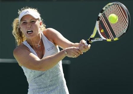 
Caroline Wozniacki of Denmark returns a shot against Vania King of the U.S. during their match at the Indian Wells WTA tennis tournament in Indian Wells, California, March 12, 2010. REUTERS/Danny Moloshok
