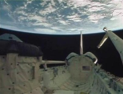 
The empty payload bay of the Space Shuttle Endeavour is seen with the earth in the background as crew members aboard the orbiter prepare for re-entry and landing in this image from NASA TV February 21, 2010. REUTERS/NASA TV
